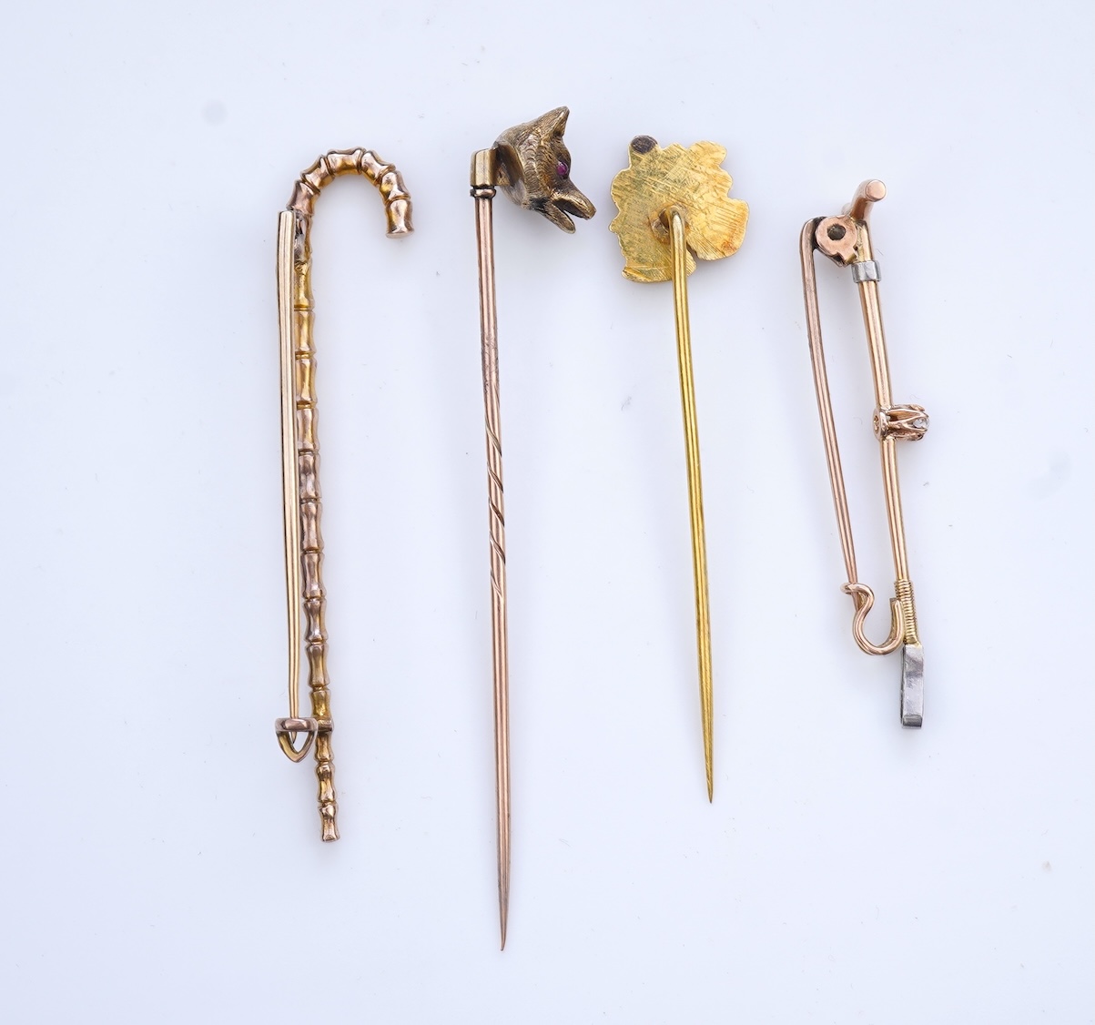 A collection of four tie pins, circa 1900